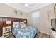 Guest bedroom with a queen bed, TV, and decorative wall at 7123 Marsh View Terrace Ter, Bradenton, FL 34212