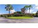 Elegant community clubhouse with palm trees and flag at 7123 Marsh View Terrace Ter, Bradenton, FL 34212