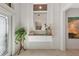 White entryway with a modern floating console and mirror at 7123 Marsh View Terrace Ter, Bradenton, FL 34212