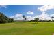 Landscaped golf course with palm trees and lake at 7123 Marsh View Terrace Ter, Bradenton, FL 34212