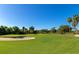 Expansive golf course with sand trap and golfer putting at 7123 Marsh View Terrace Ter, Bradenton, FL 34212