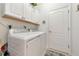 Laundry room with washer, dryer, and white cabinets at 7123 Marsh View Terrace Ter, Bradenton, FL 34212