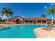 Community swimming pool with lounge chairs and clubhouse at 7123 Marsh View Terrace Ter, Bradenton, FL 34212