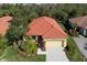 Attractive single-story home with a red tile roof, well-manicured landscaping, and a two-car garage at 735 Foggy Morn Ln, Bradenton, FL 34212