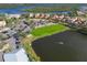 Aerial view of community, highlighting homes, parking and pond at 735 Foggy Morn Ln, Bradenton, FL 34212