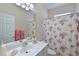 Clean bathroom with floral shower curtain and updated vanity at 735 Foggy Morn Ln, Bradenton, FL 34212