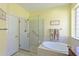 Large bathroom with walk-in shower, soaking tub, and granite vanity at 735 Foggy Morn Ln, Bradenton, FL 34212