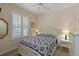 Bright bedroom with a comfortable bed and window shutters at 735 Foggy Morn Ln, Bradenton, FL 34212