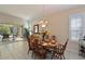 Bright dining room with sliding doors to pool area and hardwood floors at 735 Foggy Morn Ln, Bradenton, FL 34212