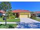 Single-story home with a two-car garage and manicured lawn at 735 Foggy Morn Ln, Bradenton, FL 34212