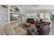 Spacious living room featuring comfortable leather furniture, a built-in entertainment center, and a cozy atmosphere at 735 Foggy Morn Ln, Bradenton, FL 34212