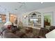 Bright and airy living room with ample seating, built-in shelving and views into kitchen at 735 Foggy Morn Ln, Bradenton, FL 34212