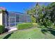 Screened-in pool area with lush landscaping at 735 Foggy Morn Ln, Bradenton, FL 34212