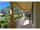 Covered front porch with white columns and view of the street at 735 Foggy Morn Ln, Bradenton, FL 34212