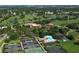 Aerial shot of the community amenities including tennis courts, pool, and clubhouse amidst lush greenery at 7412 Links Ct, Sarasota, FL 34243