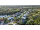 Neighborhood aerial shot, featuring the property surrounded by lush trees and greenery with waterfront views at 7412 Links Ct, Sarasota, FL 34243