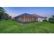 Backyard view of the home with a screened-in pool at 7412 Links Ct, Sarasota, FL 34243