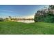 Lush green backyard overlooking a serene lake at 7412 Links Ct, Sarasota, FL 34243