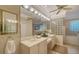 Well-lit primary bathroom with double vanity, glass block accents, and soaking tub at 7412 Links Ct, Sarasota, FL 34243