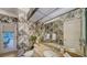 Bathroom featuring patterned wallpaper, granite counters, and views of the patio at 7412 Links Ct, Sarasota, FL 34243