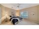 Bright bedroom with a ceiling fan, neutral walls, and large window at 7412 Links Ct, Sarasota, FL 34243