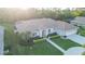 Inviting home with manicured lawn, features a tile roof, and three-car garage in a tranquil neighborhood at 7412 Links Ct, Sarasota, FL 34243