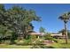 Beautifully landscaped common area featuring a gazebo, pond, and lush greenery on a sunny day at 7412 Links Ct, Sarasota, FL 34243