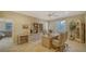 Spacious home office with built-in shelves, tile floors, and a ceiling fan at 7412 Links Ct, Sarasota, FL 34243