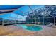 Inviting screened-in pool with scenic lake views at 7412 Links Ct, Sarasota, FL 34243