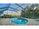 Inviting pool and spa area with beautiful landscaping and lake view at 7412 Links Ct, Sarasota, FL 34243