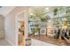 Home wet bar boasts glass shelving and granite countertop, perfect for entertaining at 7412 Links Ct, Sarasota, FL 34243