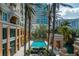 Aerial view of community pool with palm trees and canal at 750 N Tamiami Trl # 314, Sarasota, FL 34236