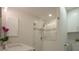 Updated bathroom with a walk-in shower, modern vanity, and marble tile at 750 N Tamiami Trl # 314, Sarasota, FL 34236