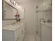 Clean bathroom with a walk-in shower, white cabinets, and new fixtures at 750 N Tamiami Trl # 314, Sarasota, FL 34236