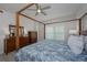 Spacious bedroom with a large bed, dresser, and window coverings at 750 N Tamiami Trl # 314, Sarasota, FL 34236