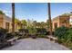 Landscaped courtyard with benches and lush greenery at 750 N Tamiami Trl # 314, Sarasota, FL 34236