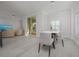 Bright dining area with modern furniture and hardwood floors at 750 N Tamiami Trl # 314, Sarasota, FL 34236