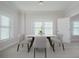 Bright dining room with a square table and four light-grey chairs at 750 N Tamiami Trl # 314, Sarasota, FL 34236