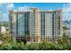 Elegant high-rise building with lush landscaping at 750 N Tamiami Trl # 314, Sarasota, FL 34236