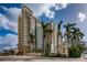 High rise building exterior with palm trees, fountain, and signage at 750 N Tamiami Trl # 314, Sarasota, FL 34236