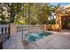 Hot tub surrounded by lush landscaping and benches at 750 N Tamiami Trl # 314, Sarasota, FL 34236