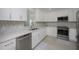 Modern kitchen with stainless steel appliances and white cabinets at 750 N Tamiami Trl # 314, Sarasota, FL 34236