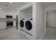 Bright laundry room with stackable washer and dryer at 750 N Tamiami Trl # 314, Sarasota, FL 34236