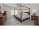 Spacious main bedroom with canopy bed and wooden furniture at 750 N Tamiami Trl # 314, Sarasota, FL 34236