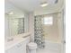 Clean bathroom with shower/tub combo, white vanity, and mirrored medicine cabinet at 7879 Bergamo Ave, Sarasota, FL 34238