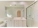 Double vanity bathroom with large mirror and shower at 7879 Bergamo Ave, Sarasota, FL 34238