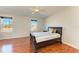 Spacious bedroom with hardwood floors, large windows, and ceiling fan at 7879 Bergamo Ave, Sarasota, FL 34238