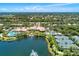 Aerial view of community amenities including pool, tennis courts and lake at 7879 Bergamo Ave, Sarasota, FL 34238