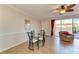 Bright dining area with glass table and chairs near living room at 7879 Bergamo Ave, Sarasota, FL 34238