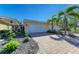 Two-car garage and well-manicured landscaping at 7879 Bergamo Ave, Sarasota, FL 34238